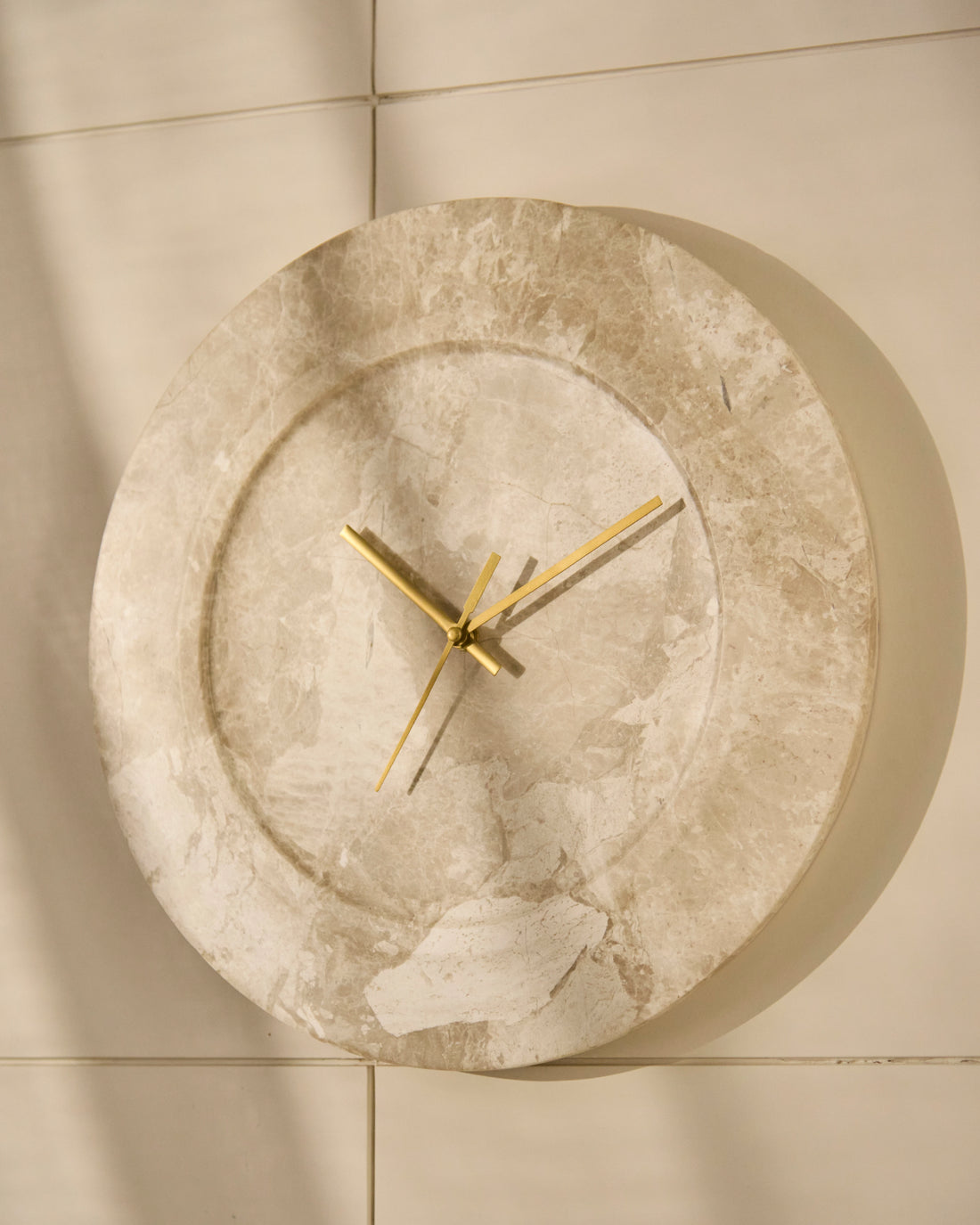 Angled view of sculptural wall clock highlighting its fluid organic form and depth