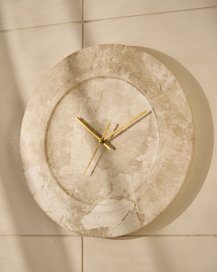 Angled view of sculptural wall clock highlighting its fluid organic form and depth