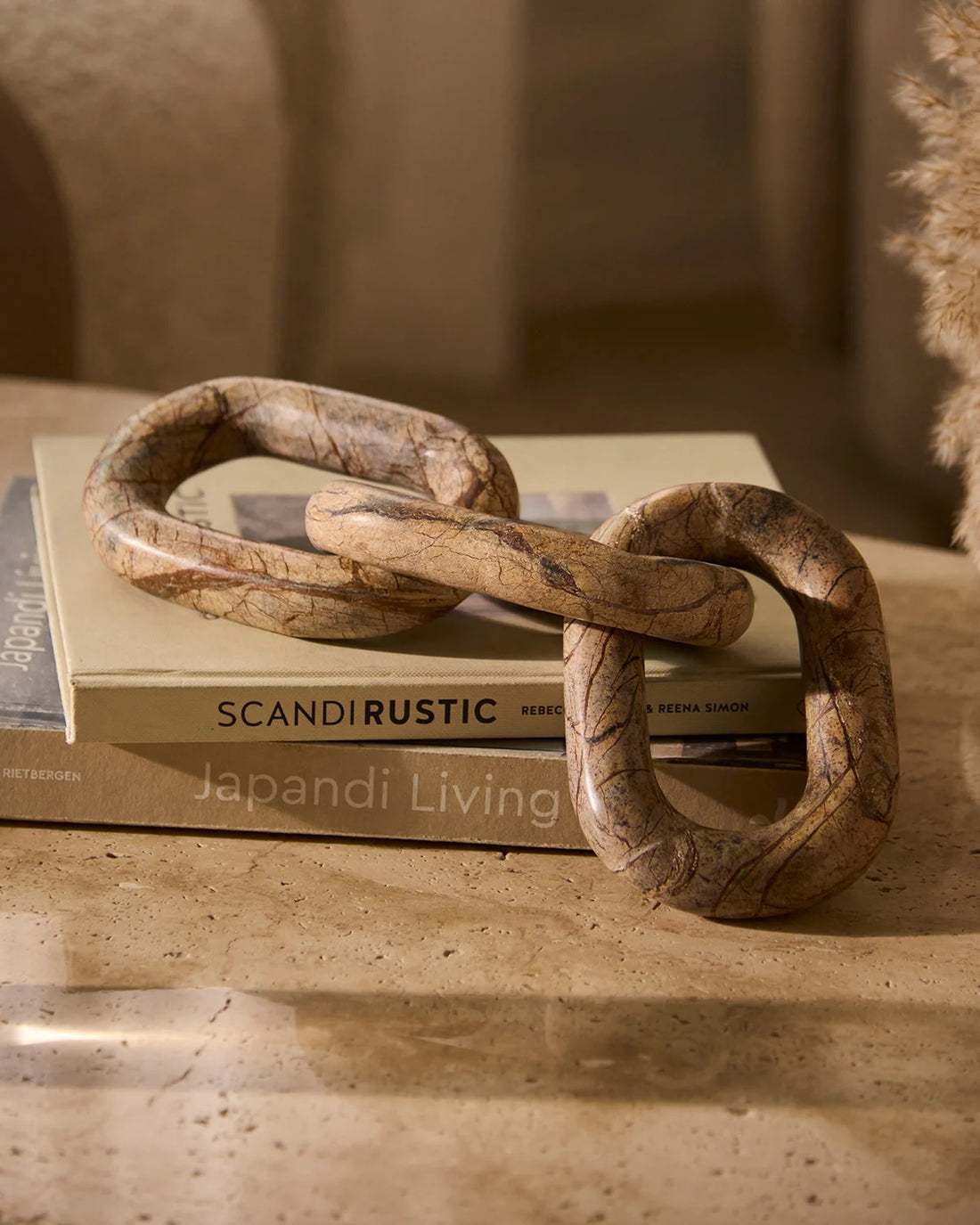 Handcrafted marble chain sculpture with natural stone veining for luxury coffee table decor
