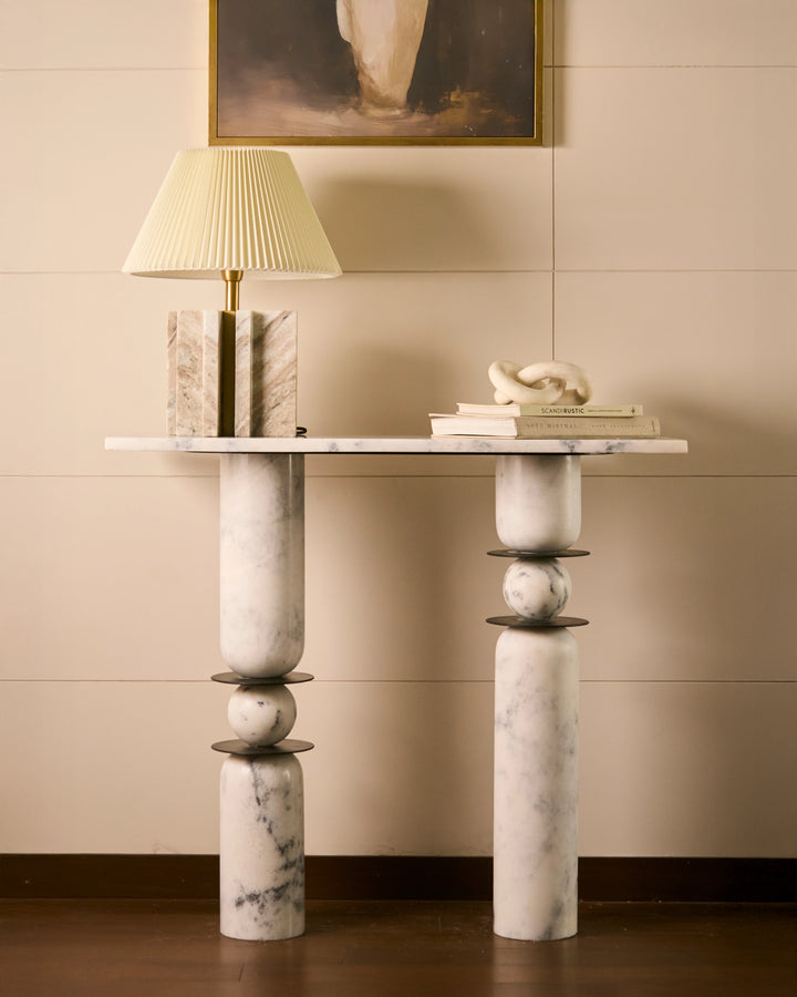 Luxury marble console table with sculptural pedestal legs and handcrafted stone details