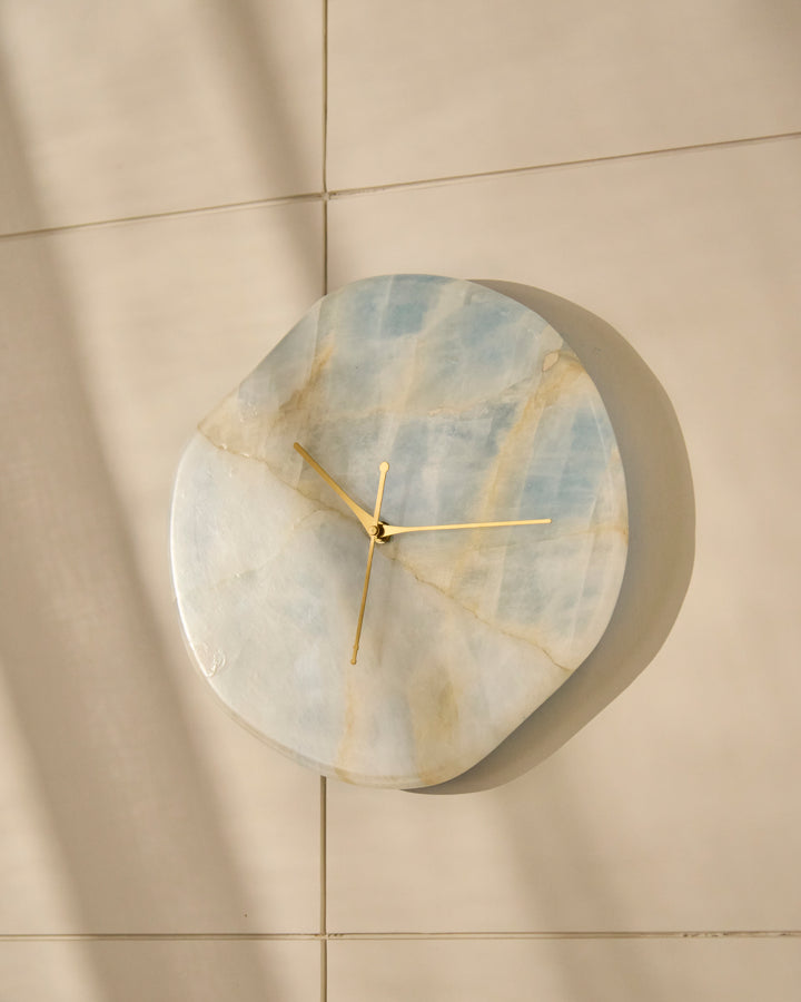 Luxury blue stone wall clock with organic silhouette and brushed gold hands